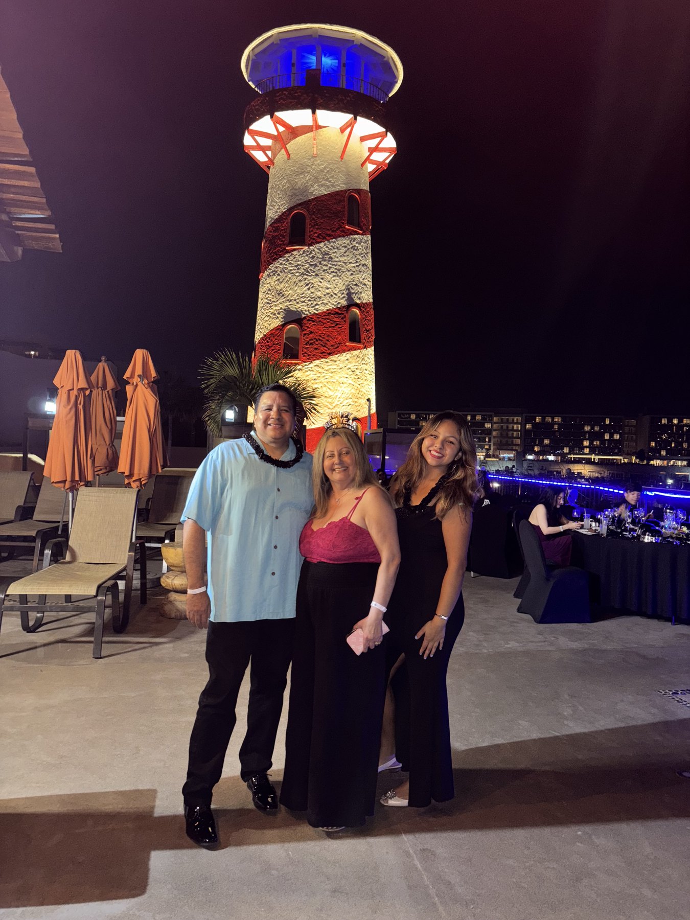 Raymond and family by the lighthouse at night